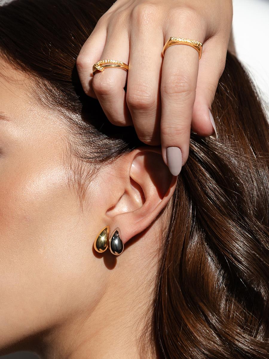 18k Gold Plated and Rhodium Curved Drop Earring Set worn by a model with rings on her fingers