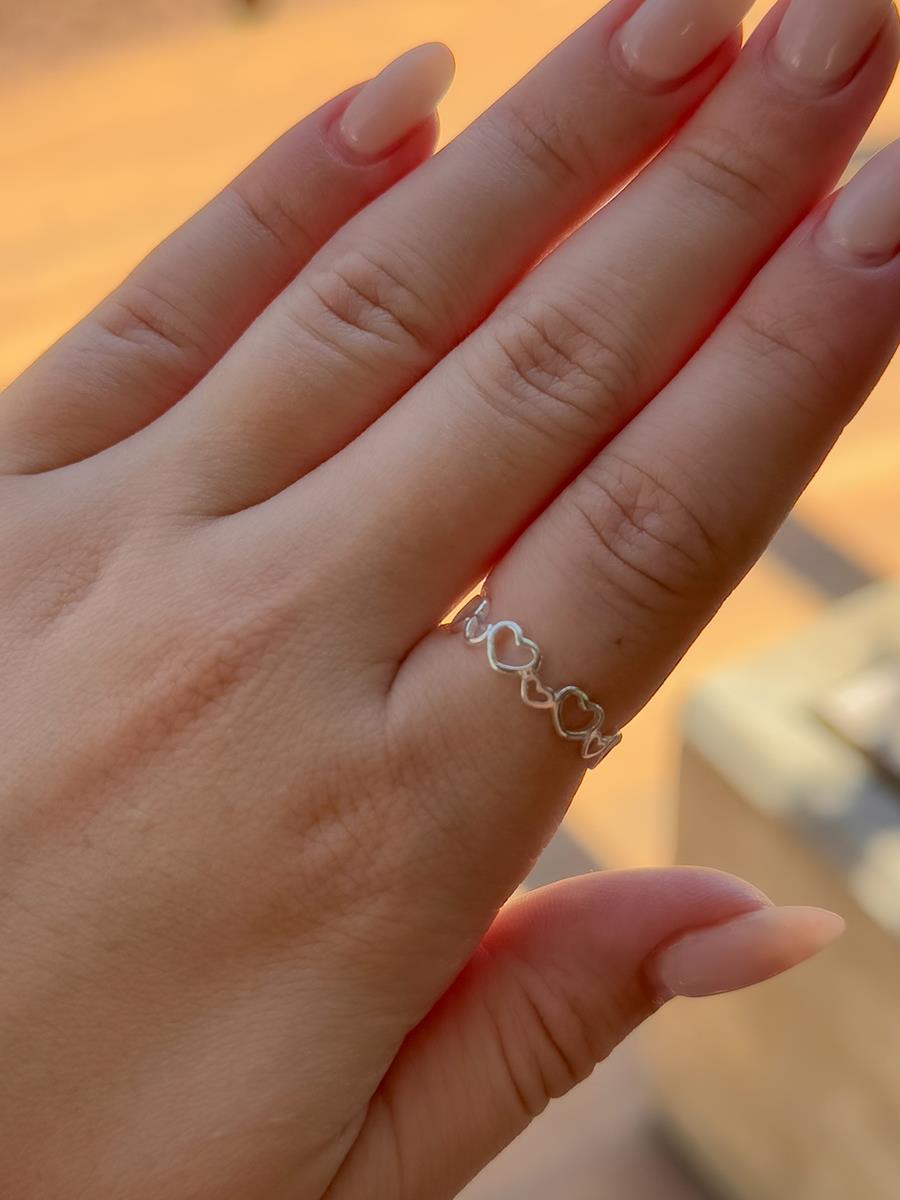 925k Silver Hollow Hearts Ring from Tamis Jewellery displayed on a hand outdoors