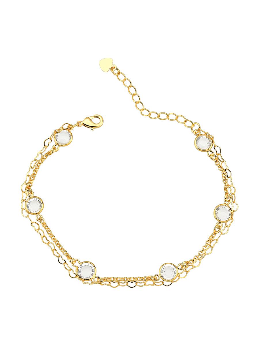 Close-up of gold heart charm and zirconia details - Brazilian jewelry