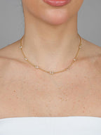 Gold colorless necklace styled with other chains - Dublin jewelry layering trend