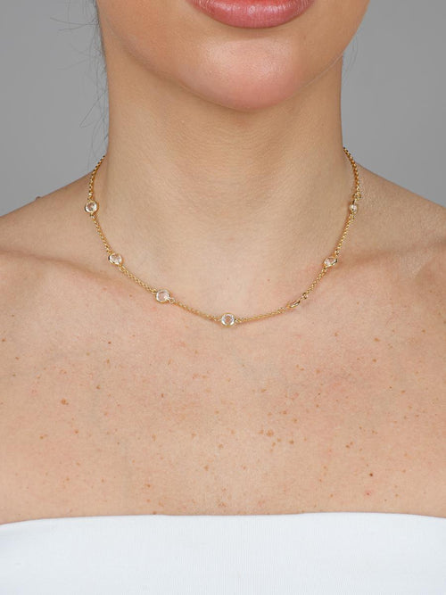 Gold colorless necklace styled with other chains - Dublin jewelry layering trend